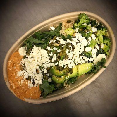 Build Your Own Bowl with half kale half brown rice, avocado, sunflower seeds, feta, broccoli and spicy almond dip.