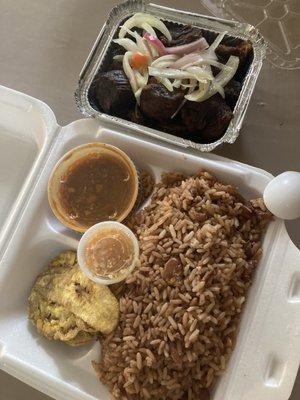 Tasot ( fried goat ) rice and beans, green plantains, picklez and gravy