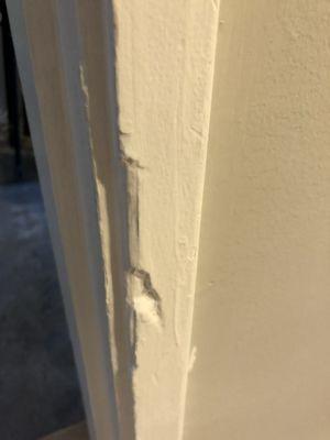 Damaged trim that was then painted over without repair.