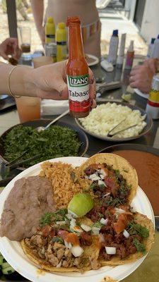 Our plates of bomb tacos and our fav hot sauce!