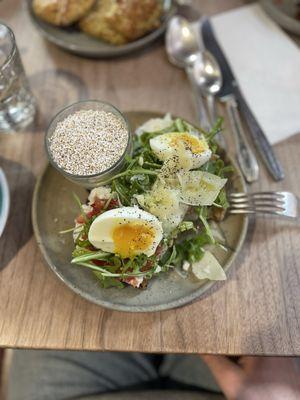 Sourdough toast with Spanish tomatoes, ricotta, arugula, Parmesan, olive oil and an egg on top. Side of yogurt topped with puffed amaranth.