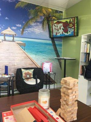 Flat screen and karaoke machine and books for reading.