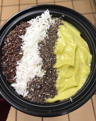 Avocado bowl with chia seeds, coconut, and cacao nibs