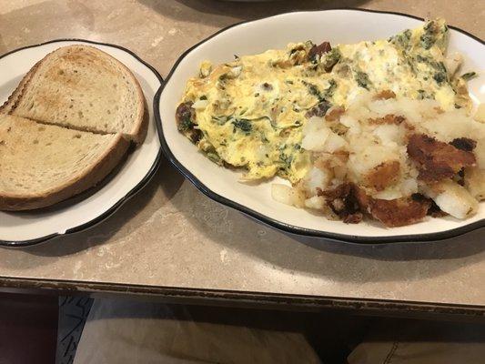 Omelette with rye toast and home fries. The omelette is good. Home fries are nice. Soft and slightly crispy at the same time.