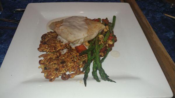 Fried sobe noodles with a steak made from ground shrimp and squid wrapped in rice paper. On the side a spicy peanut grilled asparagus.