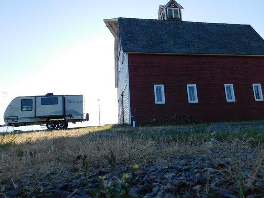 Barn sunrise with Winnebago Trailer