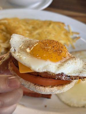 Another sunny side egg on top of English muffin, sliced tomatoes, ham (from the ham and eggs), and slice of American cheese!