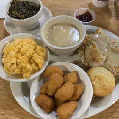 Mac and cheese  Cornbread Corn nuggets Turnip greens   And homemade chicken and dressing