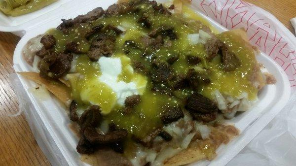 Carne asada nachos with salsa verde