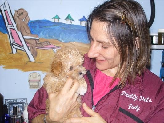 Owner Judy Carter with a puppy getting its first haircut