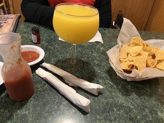 Mango margarita with chips and salsa.