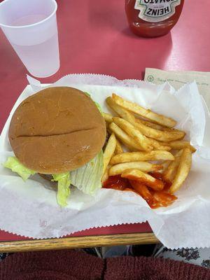 A Burger with partially eaten fries for roughly $8.00.