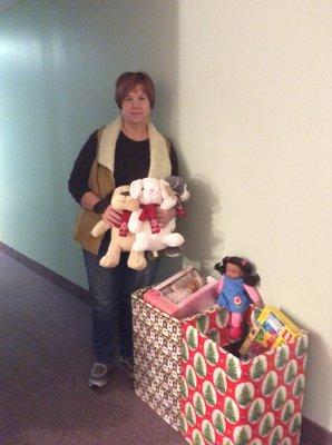 Therapist Darla Goddard holds toys our clients donate every year to needy Alexandria families.