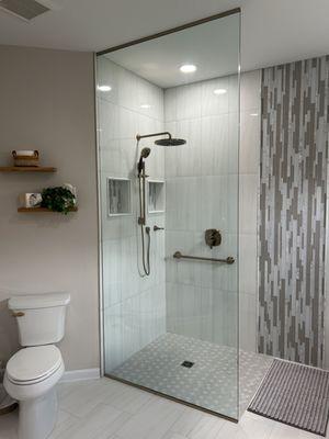 Floor to ceiling glass shower panel.