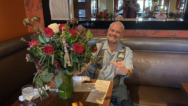 My husband loving his flowers designed and delivered to the restaurant by, Danville Florist!