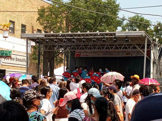 Asian dancers on stage at the Chinatown Summer Fair.