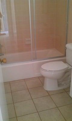 bathroom modernization - new tile, toilet, doors, reglaze tub