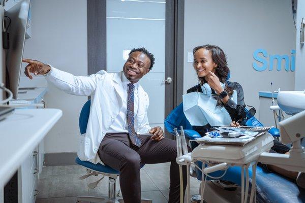 Dr. A walking a patient through their dental scans at Smile Design Dental Studio