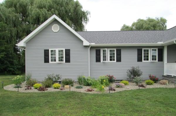 Landscaping completed with 2B stone and specific plantings selected  for color and low maintenance  and easy to mow around.