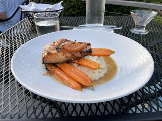 Salmon over carrots and risotto