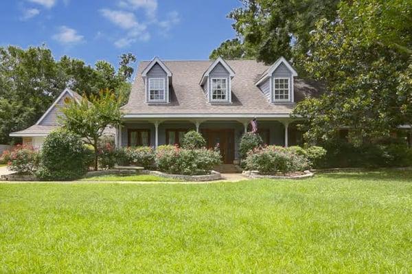 Acadian with a private back pool and patio area.