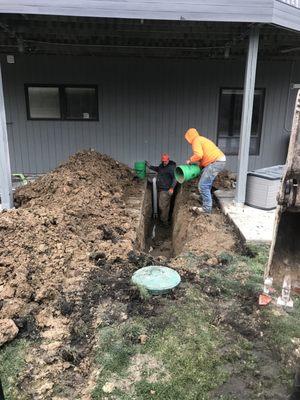 Installation of PVC Pipe to replace failed cast iron outlet to septic box