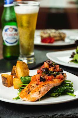 Salmon fillet dressed in a passion fruit sauce served w/ asparagus and roasted potatoes