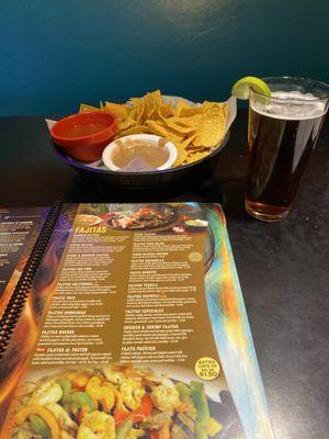 Chips are served with both bean dip and salsa. They also have a salsa bar for more tasty selections. Draft dark Dos Equis.