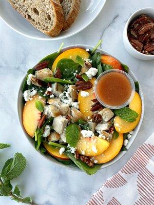 Seasonal item: Peaches from Lightsey Farms, pecans, goat cheese, mint, roasted cage-free chicken, spinach, Swiss chard, rosé vinaigrette.