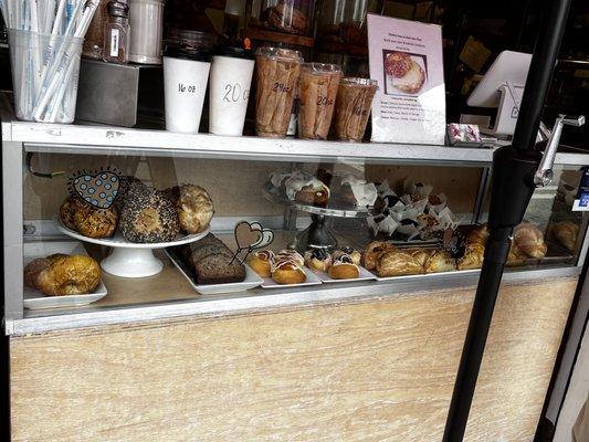 Display case featuring baked goods and hot drinks