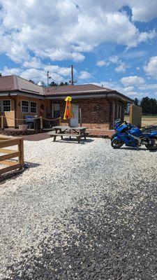 Long picnic table, probably for ice cream customers, more seating on deck