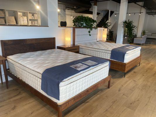 Naturepedic Organic EOS Pillow-Top Mattress displayed with 100% walnut platform bed