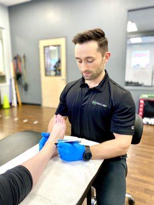 ProClinix Armonk Physical Therapist Dr James Cassell using Graston Techniques on peroneal tendonitis