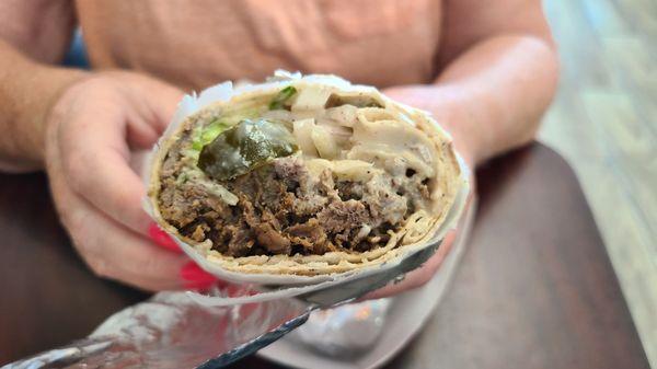 Inside of a beef shawarma wrap, big sandwich with lots of meat