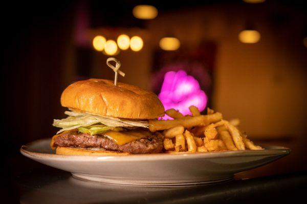 Rosis Burger made with "Escabeche", beef patty, cheddar cheese, lettuce, pickled onions, our chileancho mayo on a brioche bun!