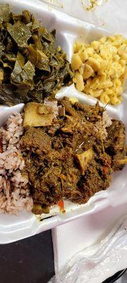 Curry goat with rice and peas - greens and mac and cheese as sides