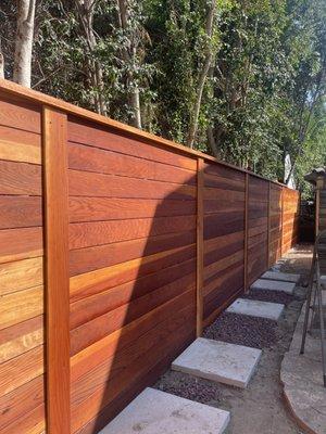 Beautiful horizontal red wood fence..