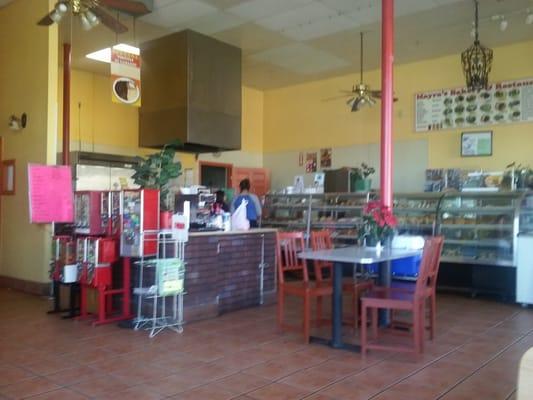 Inside the diner/bakery. Menu above bakery display.