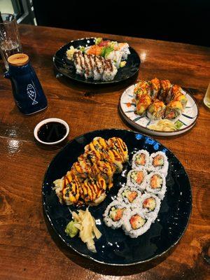 Front: Friday Night Roll Spicy Tuna Roll Middle: Cherry Blossom Roll Back: Rainbow Roll Shrimp Tempura Roll