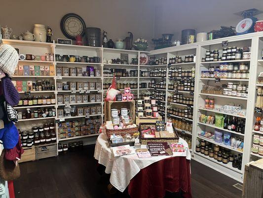 Shelves full of local jams, jellies, honey, coffee and teas.