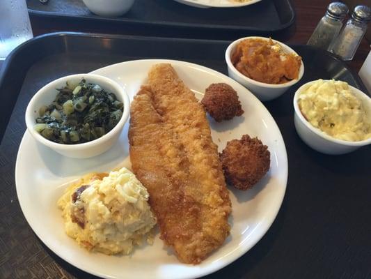 Cod fish, greens, Mac n cheese, mustard potato salad and sweet potato soufflé