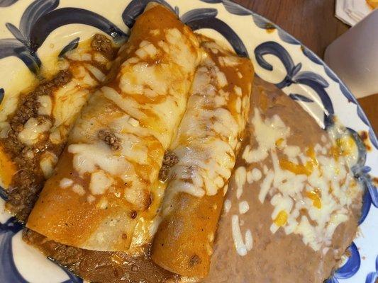 Two ground beef enchiladas with refried beans