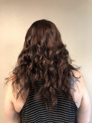 Deep auburn hair styled with flat iron curls