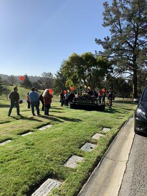 Family have a ballon release at graveside