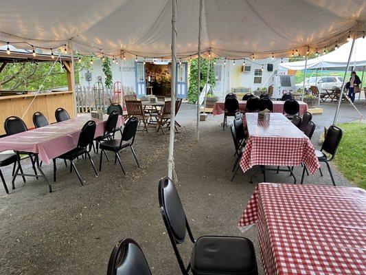 Lots of Outdoor dining under a tent.