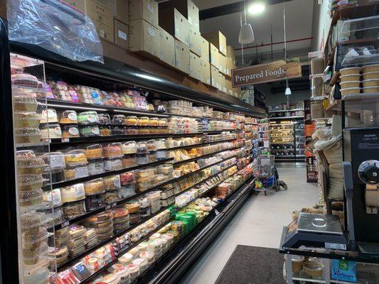 Shelves of cakes and a prepared food section