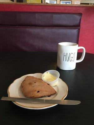 White chocolate raspberry scone and ample mug of coffee.