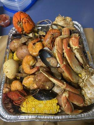 Seafood boil --- lobster-shrimp-crawfish-black mussels-clams-dungeons crab-king crab- sausage-corn-potato-egg