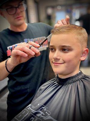 Action shot of "kid"s haircut"