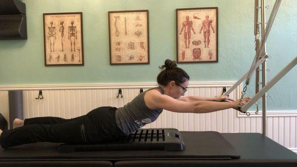 Back extension stretch using the Backsync SEG-G and Pilates Tower, focused on mobilizing the spine and ribcage.